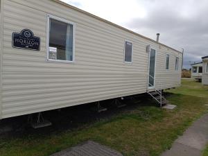 a mobile home with a sign on the side of it at Elli-Roo's cabin in Hartley