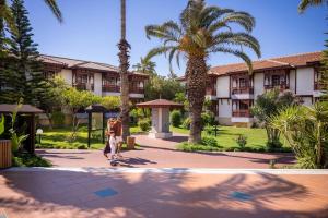 a person riding a skateboard in front of a building at Ali Bey Club & Park in Kizilagac