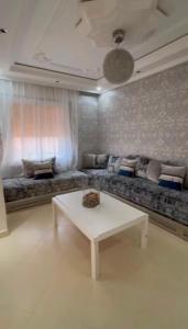 a living room with a couch and a table at naderi in Tangier