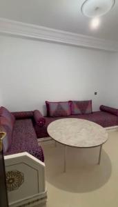 a living room with a couch and a table at naderi in Tangier