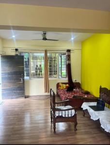 a living room with a couch and a bed in it at Stay in Forest in Haldwāni