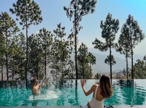two people playing in the water in a swimming pool at Dhensa Resort in Punākha +22 photos