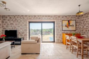 a living room with a brick wall at Rustic Stone House with Spacious Terrace 2BR in Burhaniye