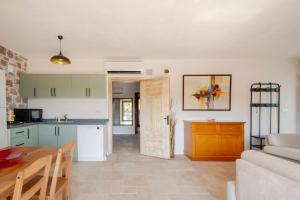 a kitchen and a living room with a table at Rustic Stone House with Spacious Terrace 2BR in Burhaniye +30 photos