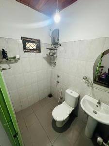 a bathroom with a toilet and a sink at The Shire in Kandy