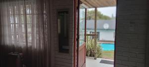 a door to a house with a view of a pool at African Sands B&B in Amanzimtoti
