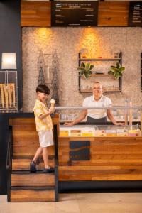 a woman standing next to a man behind a counter at Ali Bey Club & Park in Kizilagac +163 photos