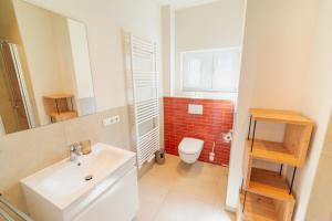 a bathroom with a white sink and a toilet at Das Schneckenhaus EG in Lathen