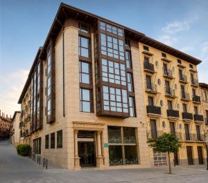 a large building with large windows on a street at Hotel Sancho Abarca Petit SPA in Huesca