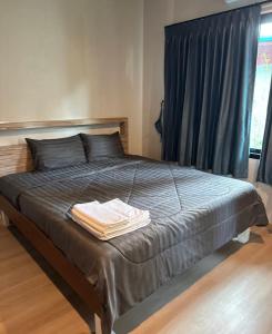 a bed with two towels on it in a bedroom at C S phangan Villa in Ban Madua Wan