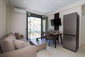 a living room with a couch and a table at Glamour Residences 5-6 by CorfuEscapes in Análipsis