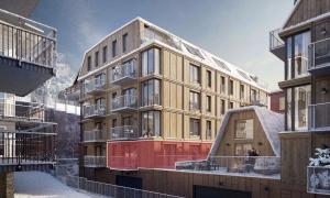a large building in the snow next to some buildings at Twintip Apartments in Åre
