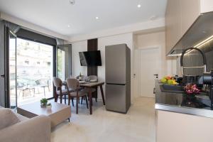 a kitchen and a living room with a table at Glamour Residences 5-6 by CorfuEscapes in Análipsis