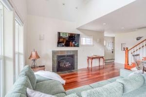 a living room with a couch and a fireplace at Twin Rocks Beach House in Rockaway Beach