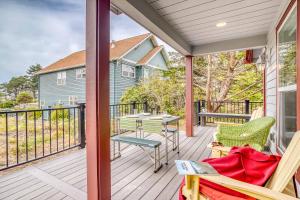 a porch with a table and chairs on it at Twin Rocks Beach House in Rockaway Beach