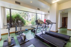 a gym with several tread machines and a large window at Hotel Eurosol Leiria & Jardim in Leiria
