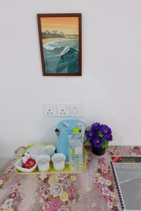 a table with a shelf with dishes and a painting at Wilpattu Lakwin Guest in Pahala Maragahawewa +53 photos