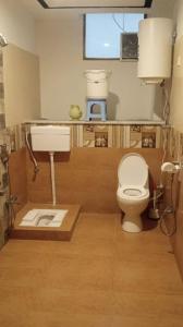 a bathroom with a toilet and a sink at Multiple Hotels in Malam Jabba Swat in Malam Jabba