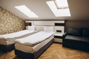 a room with two beds and a chair in it at Полінарія Козятин in Kozyatyn