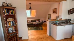 a kitchen and a living room with a couch at Ferienwohnung Eule in Kastellaun