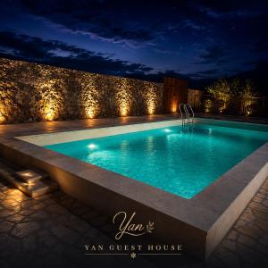 a swimming pool at night with lights at Yan Guest House in Gyumri