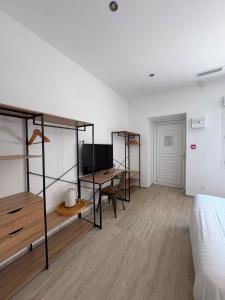 a bedroom with a bed and a desk and a bed at Rovotel - Le Rove in Le Rove
