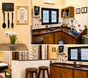 a kitchen with wooden cabinets and a sink and stools at Goan Villa Anjuna Beach in Anjuna