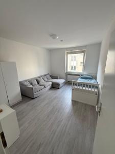 a living room with a couch and a table at Monteurzimmer Schölerpad 24h Self Check in in Essen