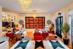 a restaurant with tables and chairs and a chandelier at MVIEW Villas in Marrakesh