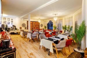 a restaurant with tables and chairs in a room at MVIEW Villas in Marrakesh
