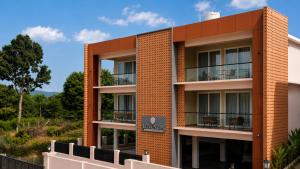 an orange brick building with a balcony at Le Venzia in Sultan Bathery