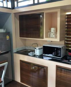 a kitchen with a counter top with a microwave at C S phangan Villa in Ban Madua Wan