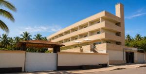 a building with a gazebo in front of it at La Costa Playa El Agua Hotel in El Agua