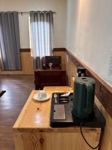 a room with a coffee maker on a table at Blue Yak Resort in She