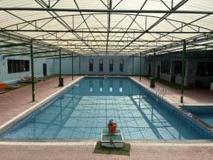 a large swimming pool with a large ceiling at Blue Yak Resort in She