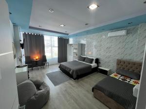 a large bedroom with a bed and a couch at Host Apartments in Shkodër