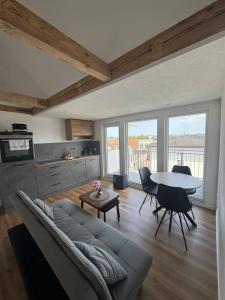 a living room with a couch and a table at Bodenseeapartments in Friedrichshafen