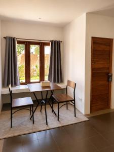 a dining room with a table and chairs and a window at Glory Moon Resort in Bophut