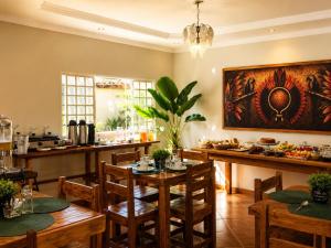 a dining room with wooden tables and chairs at Villa das Calliandras in Chapada dos Guimarães