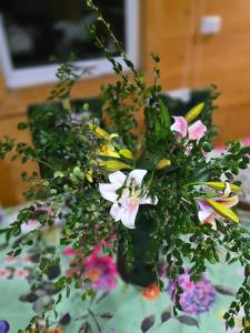 a vase filled with flowers on a table at Casa de las Flores in Panguipulli
