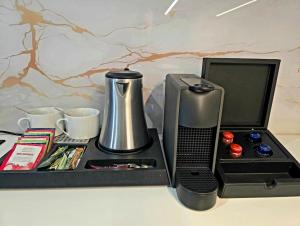 a tray with a coffee maker and a tea kettle at Design & Wine Vila Special Bled in Bled