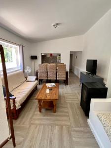 a living room with a couch and a table at Off-grid Guest House in the Algarve in Portimão