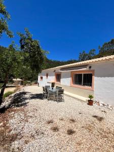 a table and chairs sitting outside of a building at Off-grid Guest House in the Algarve in Portimão
