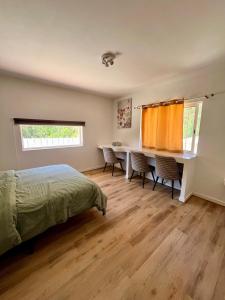 a bedroom with a bed and a desk and a window at Off-grid Guest House in the Algarve in Portimão