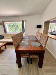 a dining room table with chairs and a couch at Off-grid Guest House in the Algarve in Portimão