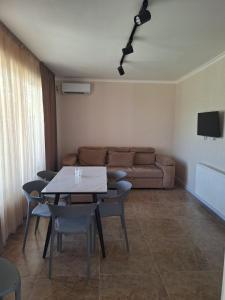 a living room with a table and a couch at Paradise Mtskheta in Tbilisi City