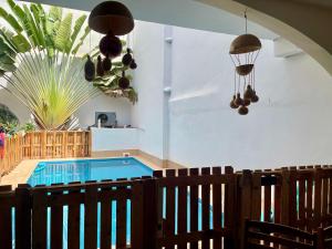 a swimming pool in a room with a table and chairs at Fadidi House in Dakar