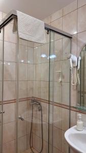 a shower with a glass door in a bathroom at Apartments Deus in Dobra Voda +54 photos