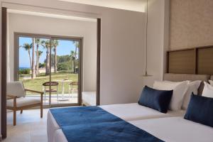 a bedroom with a bed and a view of the ocean at Atlantica Callisto in Ayia Napa +92 photos