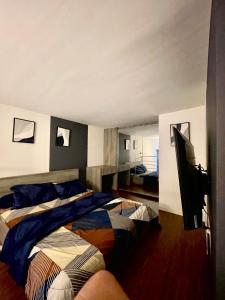 a bedroom with two beds and a flat screen tv at Deed Apartemen in Gresik